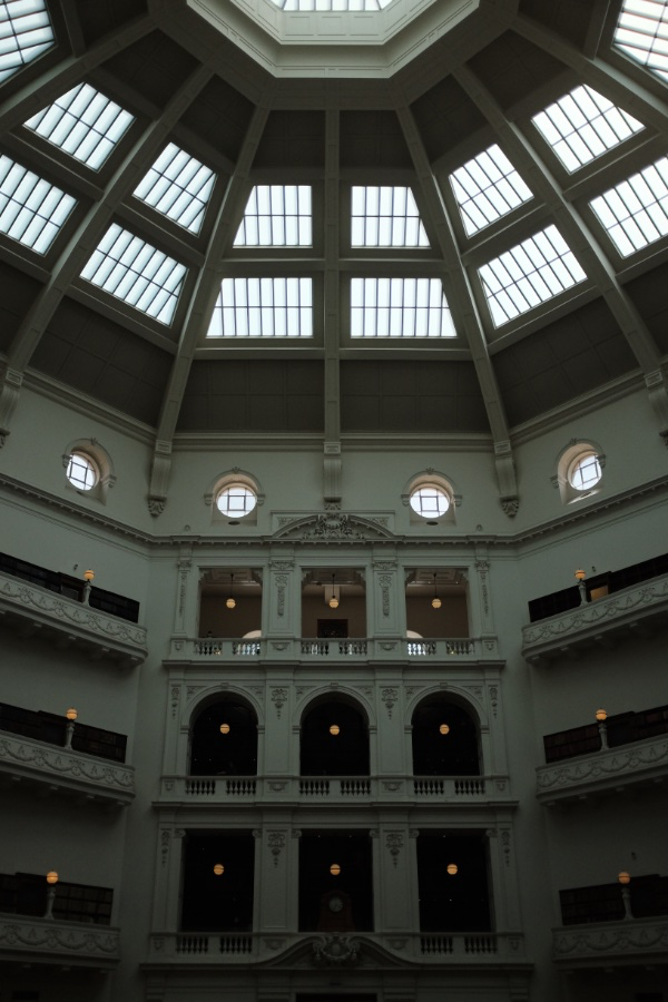 A photo of Victoria Library's interior, showing the top floors and roof of a circular room 